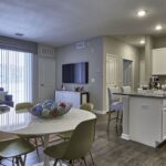 Open concent apartment home with kitchen, living, and dining areas - Elements at Prairie Center