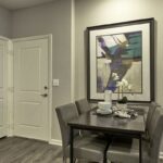 Apartment home with entry and closet doors, dining space, and bathroom door - Elements at Prairie Center
