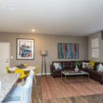 Apartment rental living room space with open kitchen - Elements at Prairie Center