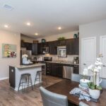 Kitchen with island and dining table in an apartment rental - Elements at Prairie Center