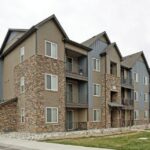 Apartment complex with stone siding and balconies - Elements at Prairie Center