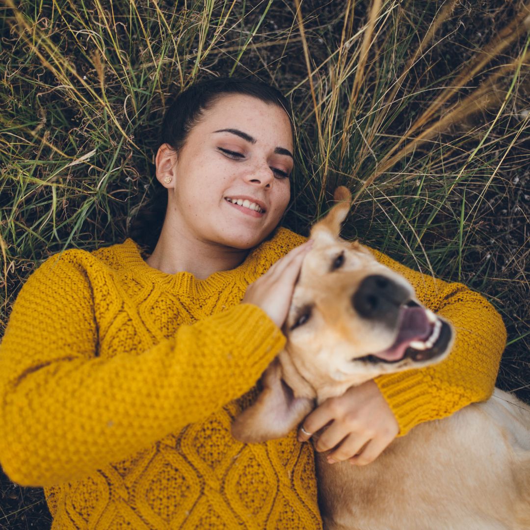 girl with dog in grass