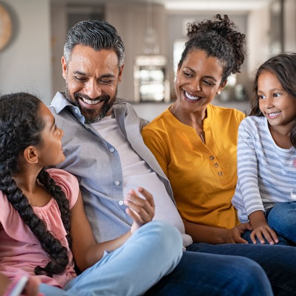 A family sitting on a couch