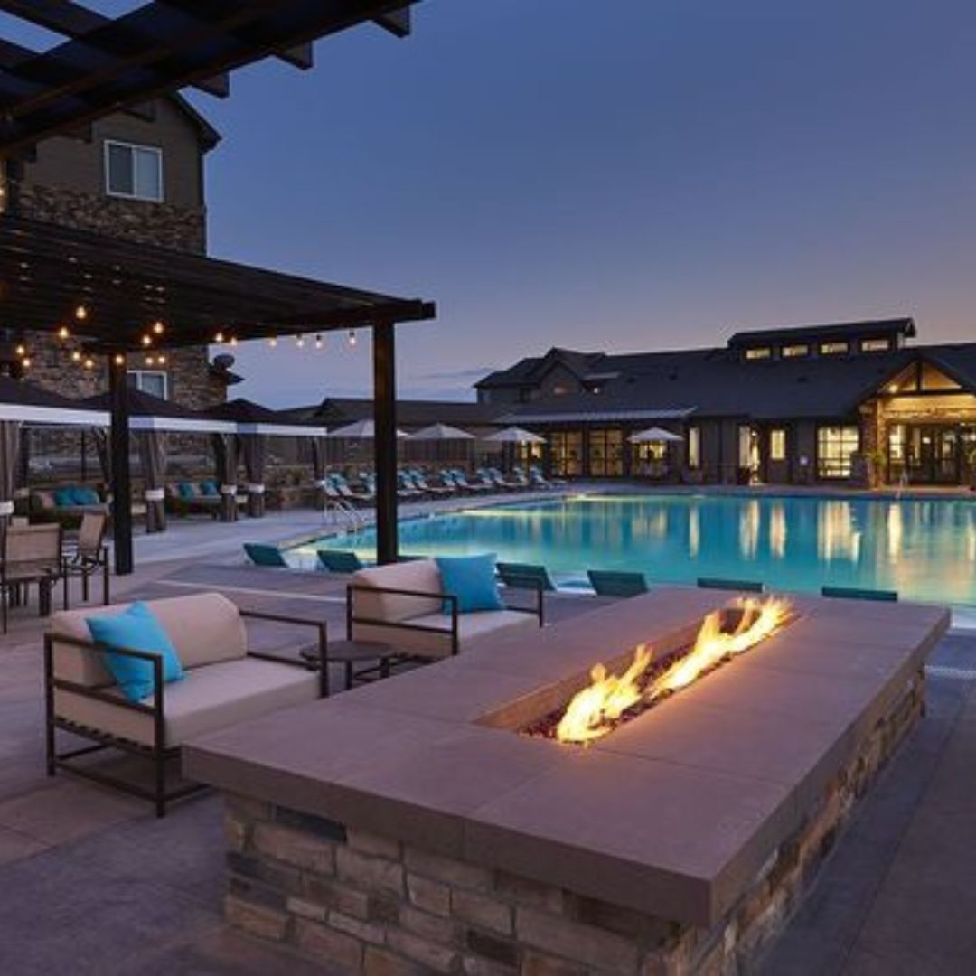 a fire pit outside by a pool