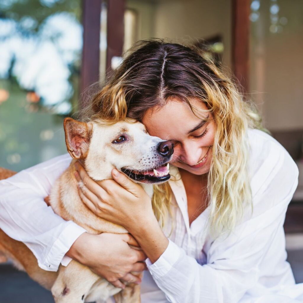 woman hugging dog