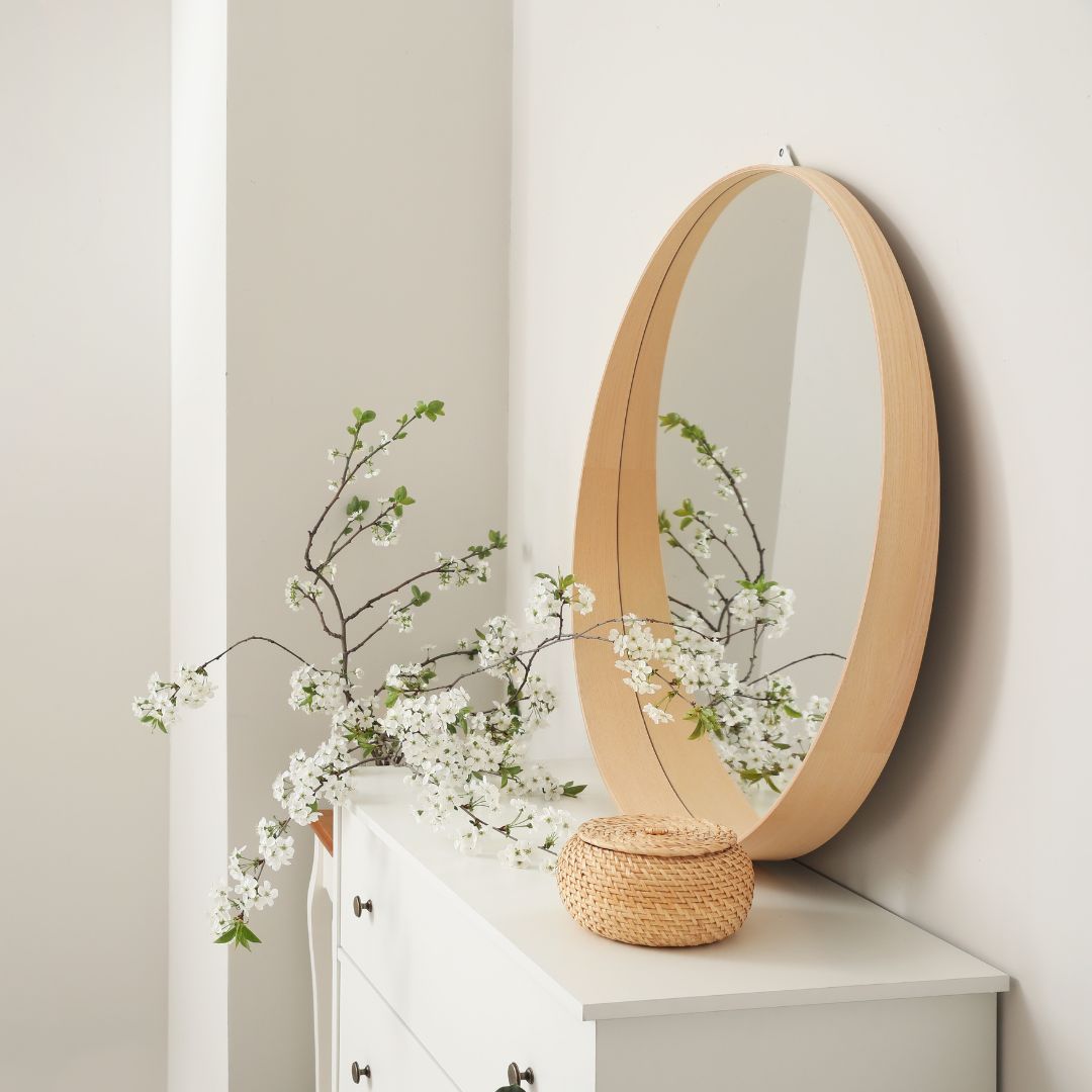 dresser with mirror and dried plants
