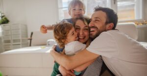 A family of four hugging