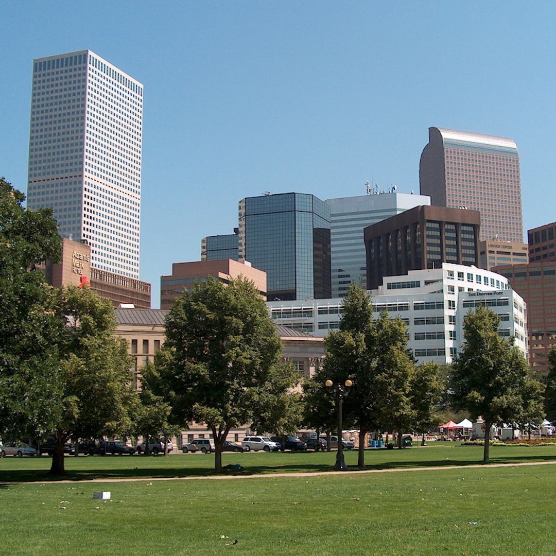 City skyline with various modern tall buildings and trees