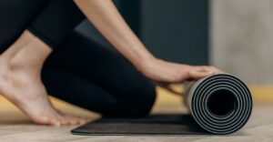woman rolling out a workout mat