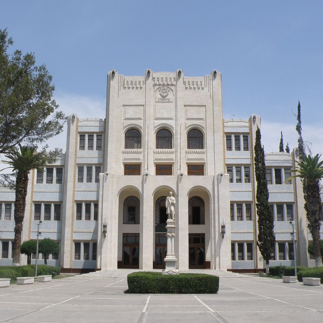 Historic white building with arched windows and statue