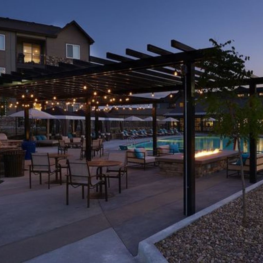 community pool and lounging area at sundown